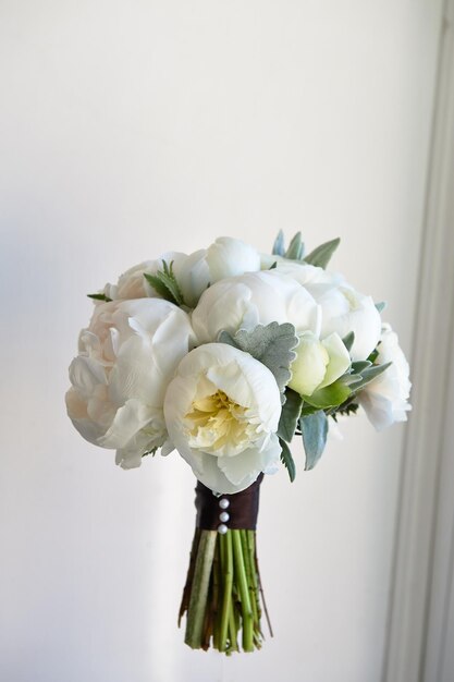 Wedding bouquet of white peonies and ranunculuses Wedding floristry