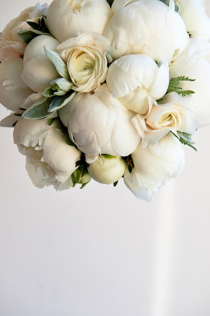 Wedding bouquet of white peonies and ranunculuses Wedding floristry