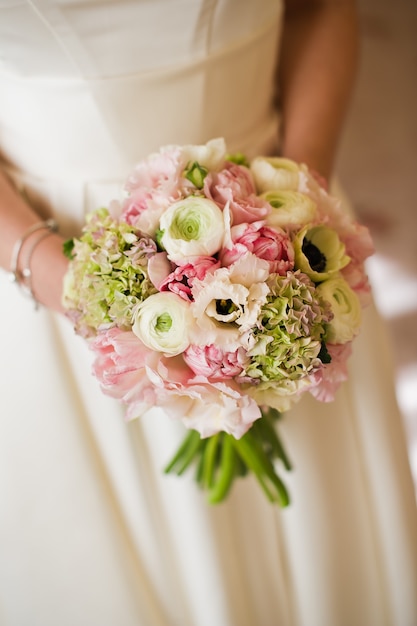 Wedding bouquet of white and pink peonies.