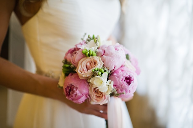 Wedding bouquet of white and pink peonies.