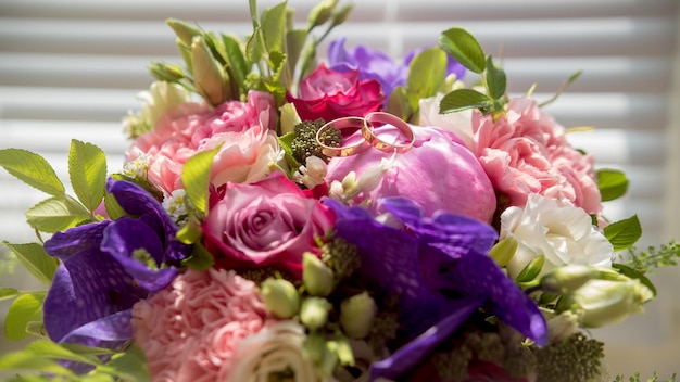 Wedding bouquet with golden rings, macro, horizontal view