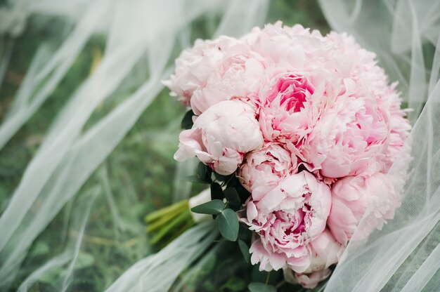 Wedding bouquet with peonies at the wedding.Beautiful bouquet of flowers.