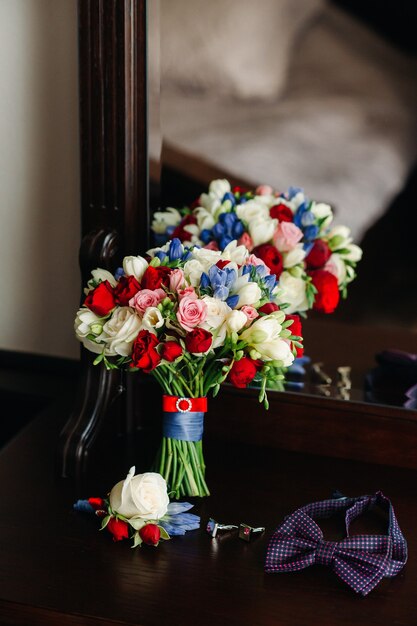 Wedding bouquet with roses and boutonniere.The decor at the wedding