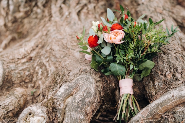 Wedding bouquet with roses and boutonniere.