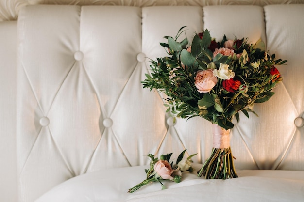 Wedding bouquet with roses and boutonniereThe decor at the wedding