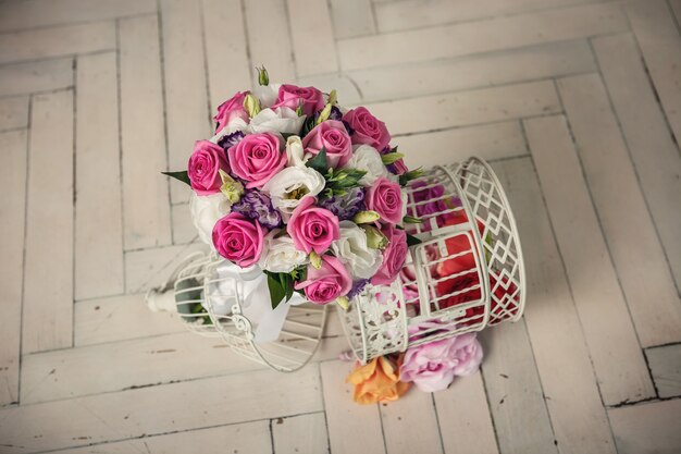 Wedding bridal bouquet of roses on the wooden white  floor