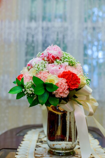 Wedding bridal bouquet with white orchids, daisies and red berries