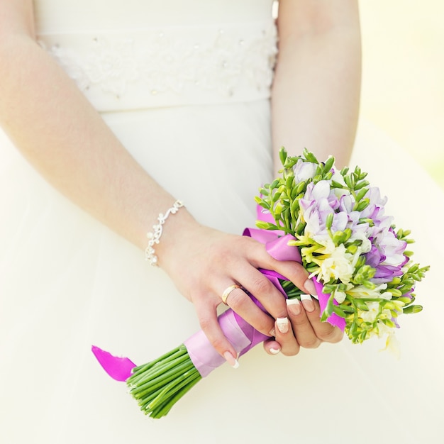 Wedding bunch of flowers in hands of the bride