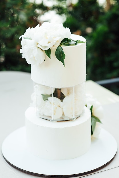 Wedding cake near arch for the evening ceremony.