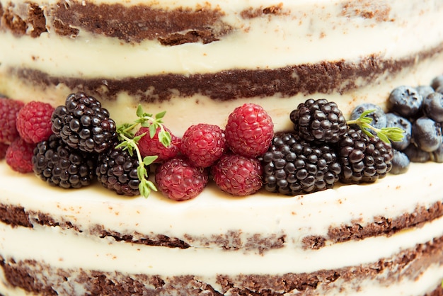 Of the wedding cake with fresh berries. Close-up.