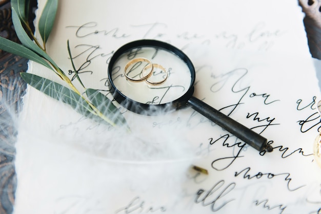 Photo wedding calligraphy and decor.inspiration. wedding invitations, envelope, cards, printing, magnifying glass, rings. selective focus