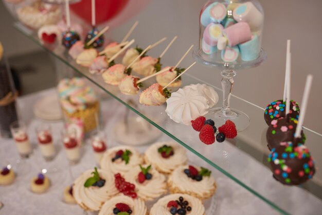 Wedding candy bar decoration setup with delicious cakes and sweets