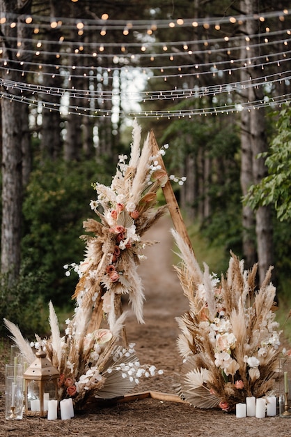 Wedding ceremony area with dried flowers in a meadow in a pine brown forest