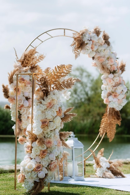 Photo wedding ceremony area with a round arch of dried flowers