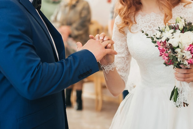 Photo wedding ceremony of exchange of rings between the bride and groom