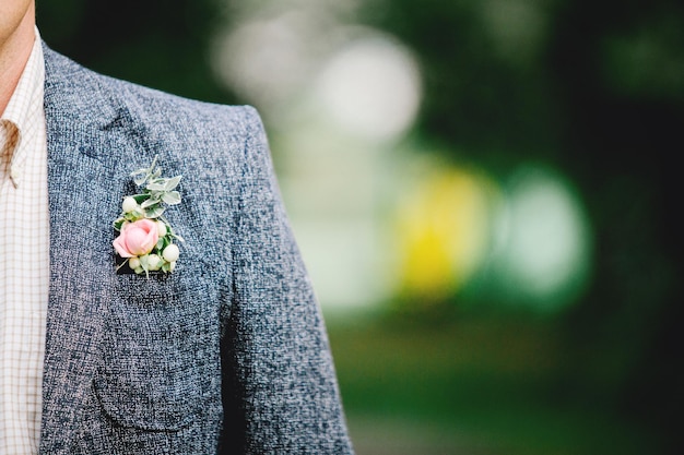 Wedding ceremony. Groom in a suit. Buttonhole on the jacket