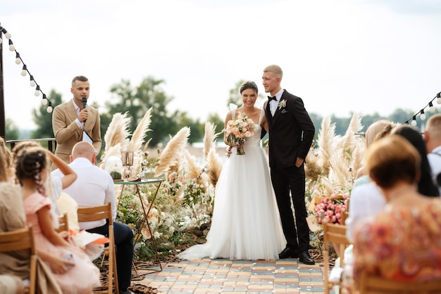 Wedding ceremony on a high pier near the river