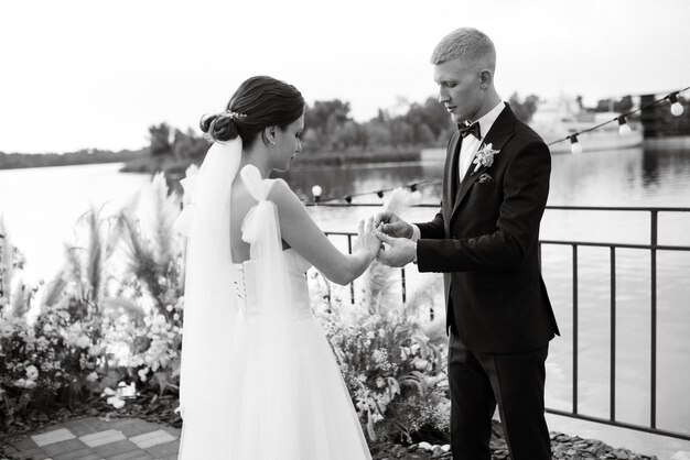 Wedding ceremony on a high pier near the river