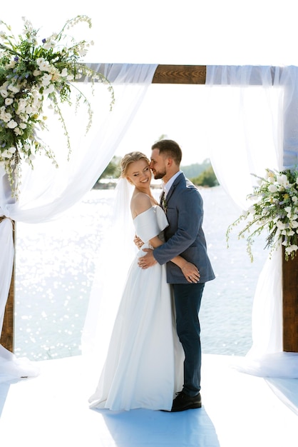 Wedding ceremony on a high pier near the river