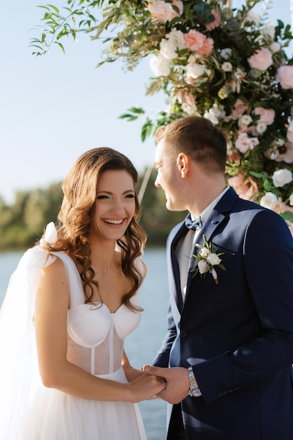 Wedding ceremony on a high pier near the river