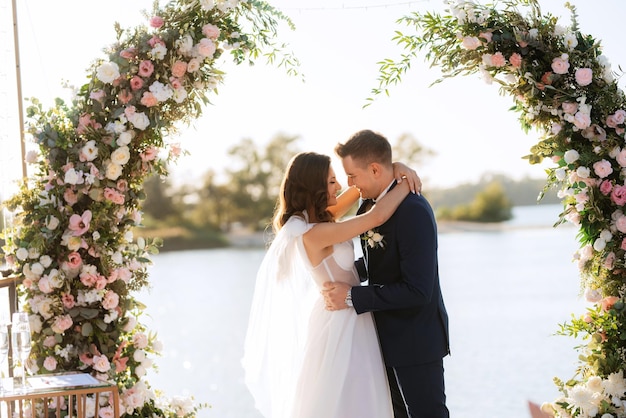 Wedding ceremony on a high pier near the river