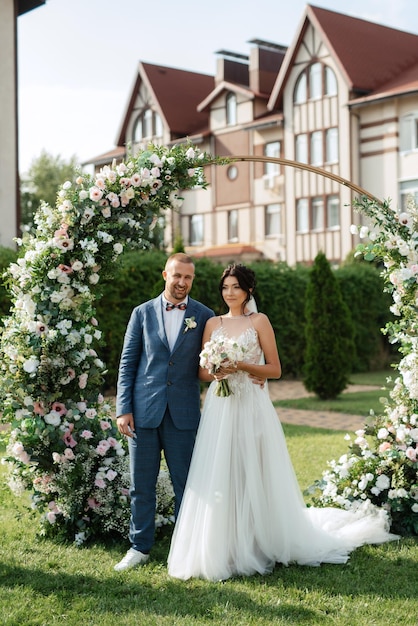 Wedding ceremony of the newlyweds on the glade