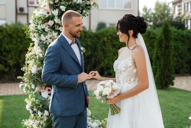 Wedding ceremony of the newlyweds on the glade