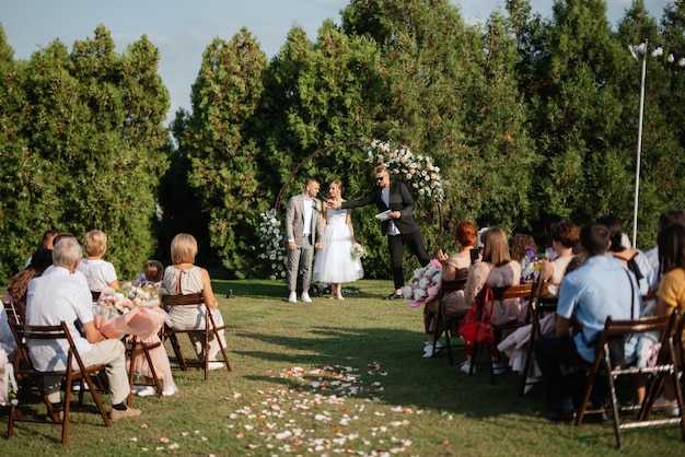 Photo wedding ceremony of the newlyweds on the glade