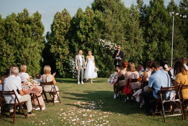 Wedding ceremony of the newlyweds on the glade