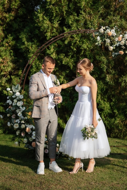 Wedding ceremony of the newlyweds on the glade