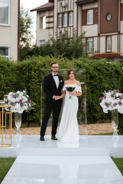 Wedding ceremony of the newlyweds on the glade