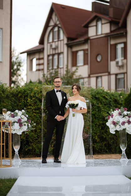 Wedding ceremony of the newlyweds on the glade