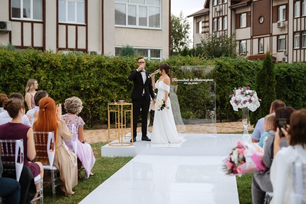 Wedding ceremony of the newlyweds on the glade