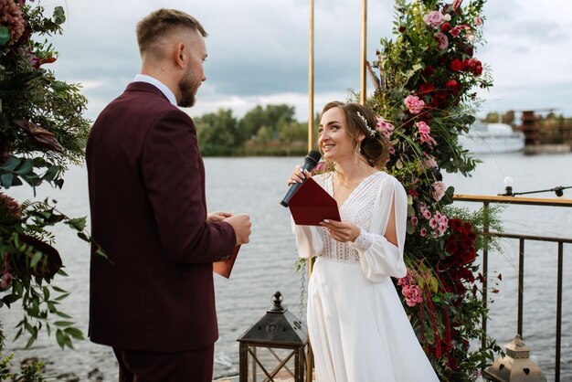 Wedding ceremony of the newlyweds on the pier