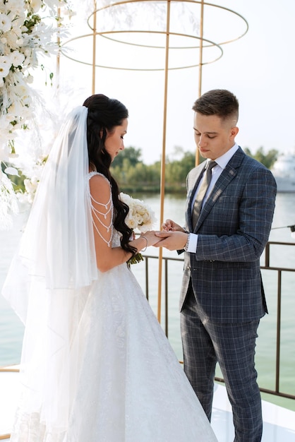 Wedding ceremony of the newlyweds on the pier