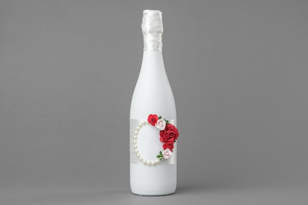 Wedding champagne bottle decorated with roses pearls and and ribbon Copy space for text