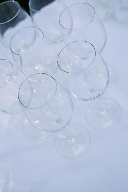 Wedding champagne glasses are on the table, on a white tablecloth in the garden. wedding.
