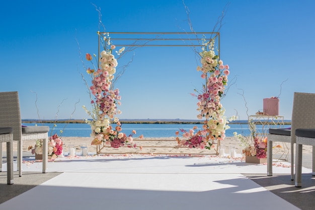 wedding chuppa at riverside decorated with fresh flowers. 