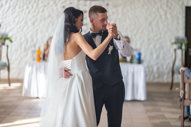 Wedding couple dancing their first dance in restaurant