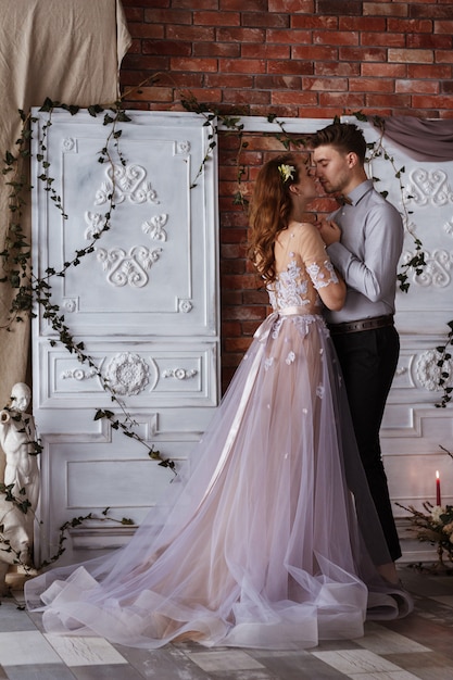 Wedding couple indoors hugging each other