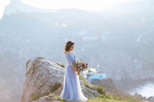 Wedding couple in love kissing and hugging near rocks on beautiful landscape.