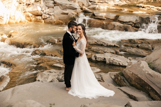 Wedding couple, lovers on the background of a stone river.