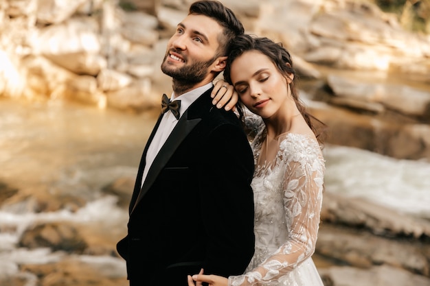 Photo wedding couple, lovers on the background of a stone river.