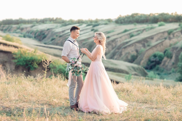 Wedding couple on the nature in summer day. the bride and groom at the wedding.