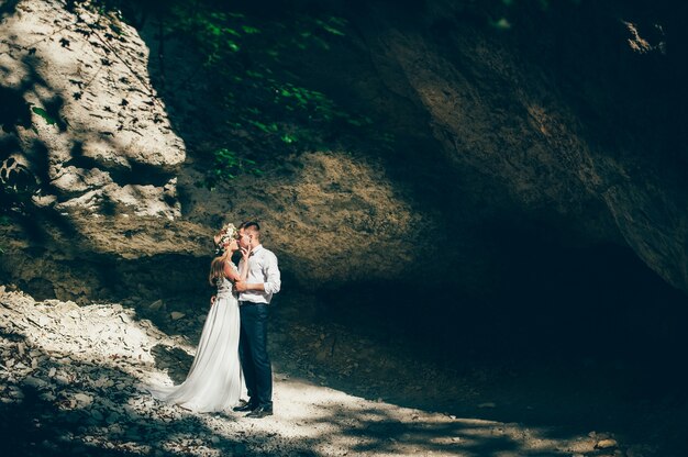 wedding couple near rock