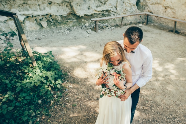 wedding couple near rock