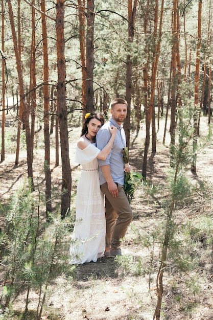 Wedding couple taking a walk in the forest