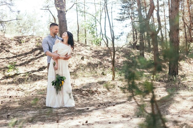 Wedding couple taking a walk in the forest