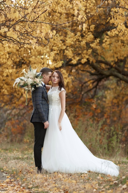 Wedding couple together standing outdoor on natural background