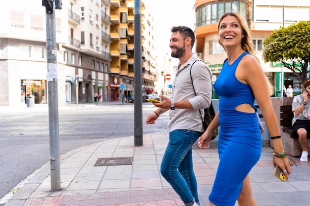 Wedding couple walking down the street smiling happy